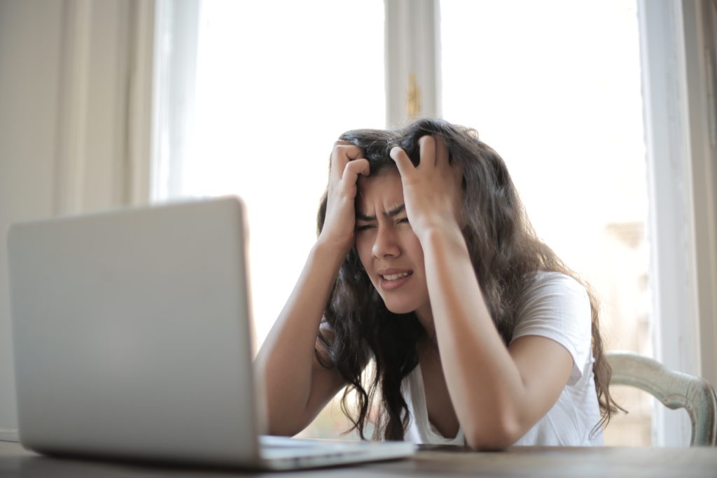 A woman frustrated at her laptop and it's slow cloud software